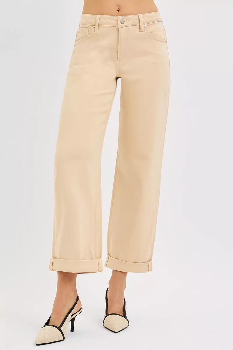 Beige wide-leg pants worn by a person on a light gray background