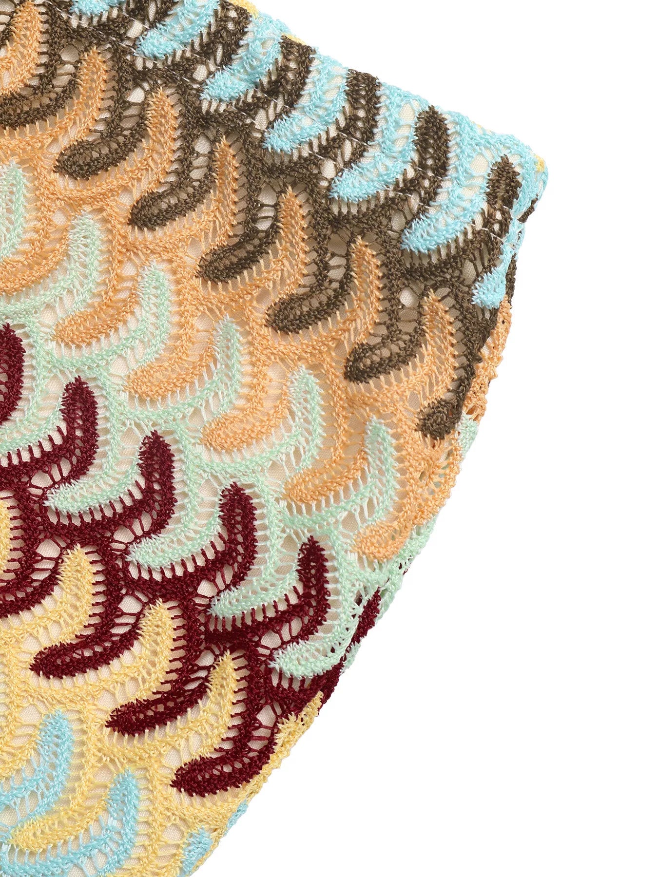 Close-up of a textured fabric with a pattern of wavy lines in brown, beige, and blue on a white background.