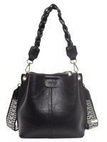 Black leather handbag with braided handle on a white background