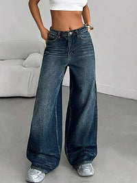 Person wearing wide-leg jeans in a minimal indoor setting