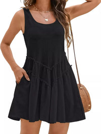 Black sleeveless dress worn by a person on a plain background