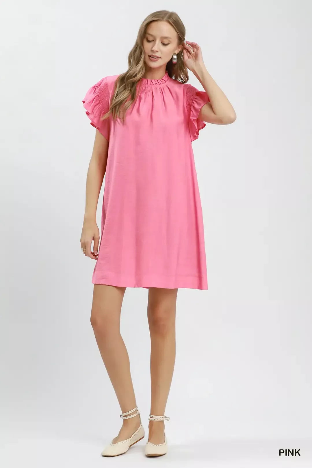 Woman wearing a pink dress on a white background