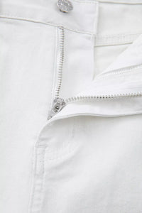 Close-up of a white denim zipper and button on a white background