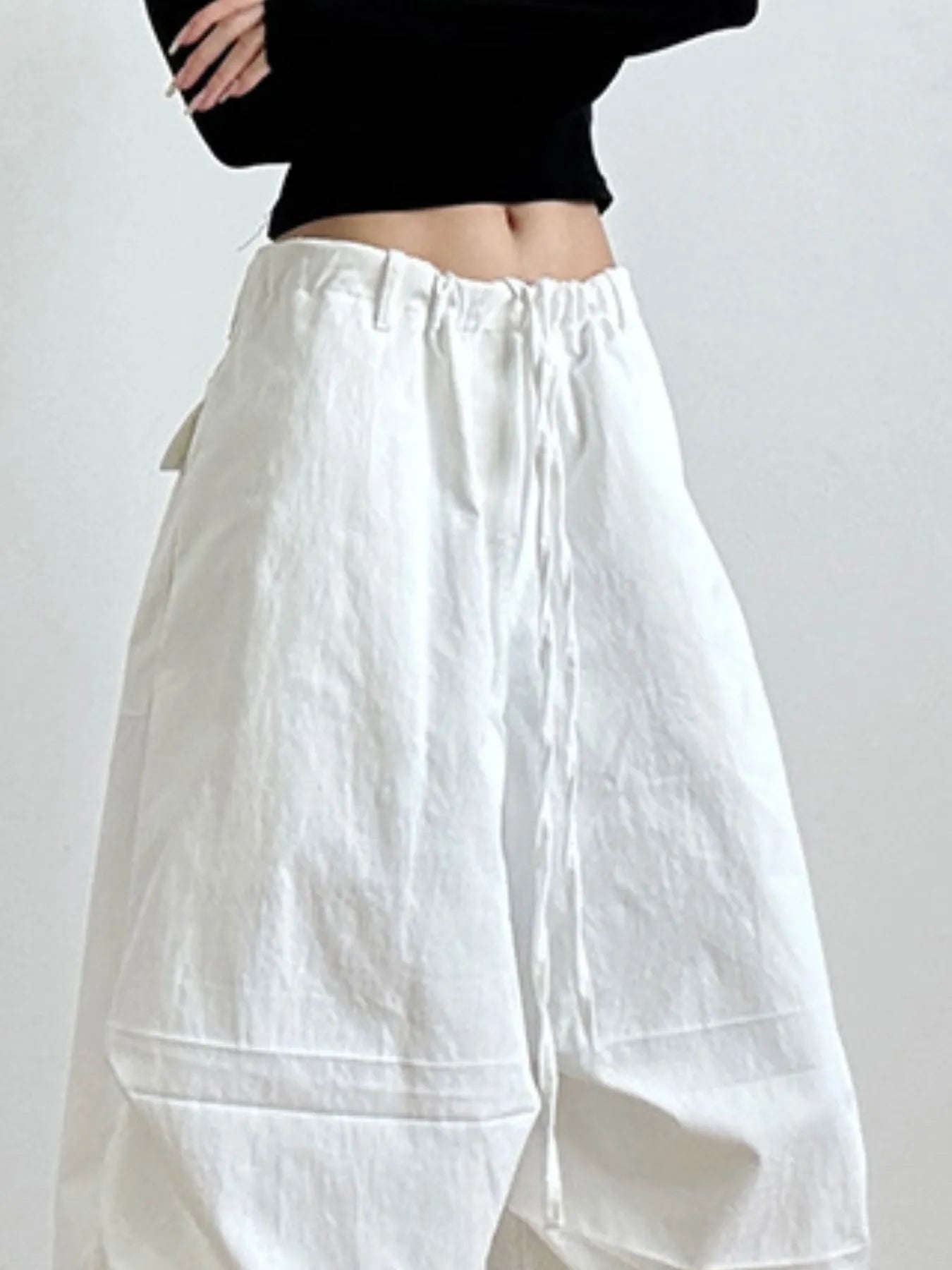 White wide-leg pants worn by a person on a plain background