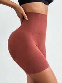 Maroon high-waisted leggings worn by a person on a white background