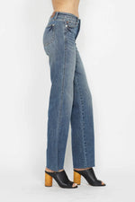 Blue jeans worn by a person on a white background