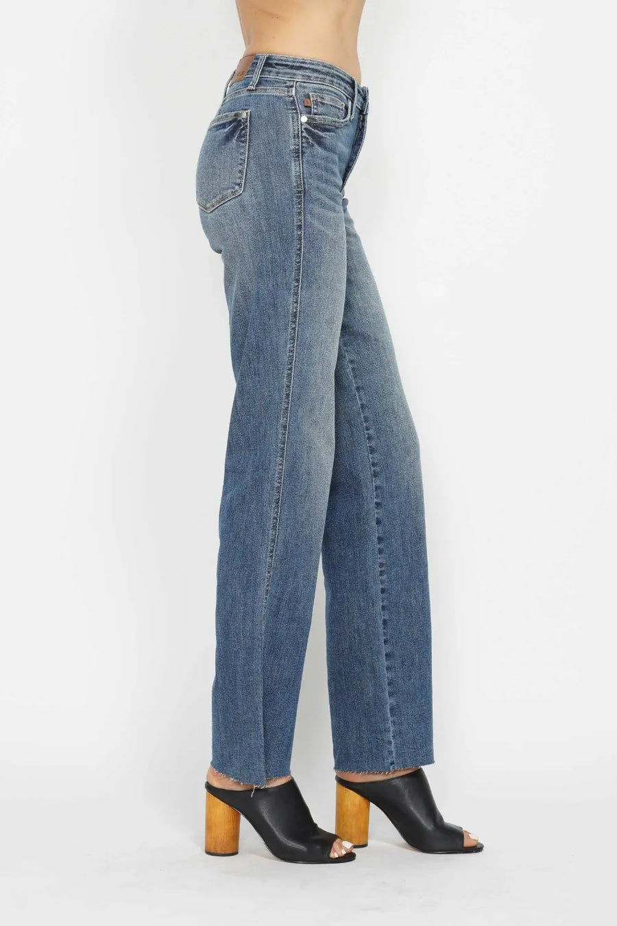 Blue jeans worn by a person on a white background
