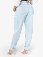 Light blue jeans worn by a person on a white background