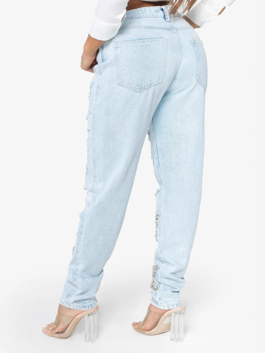 Light blue jeans worn by a person on a white background