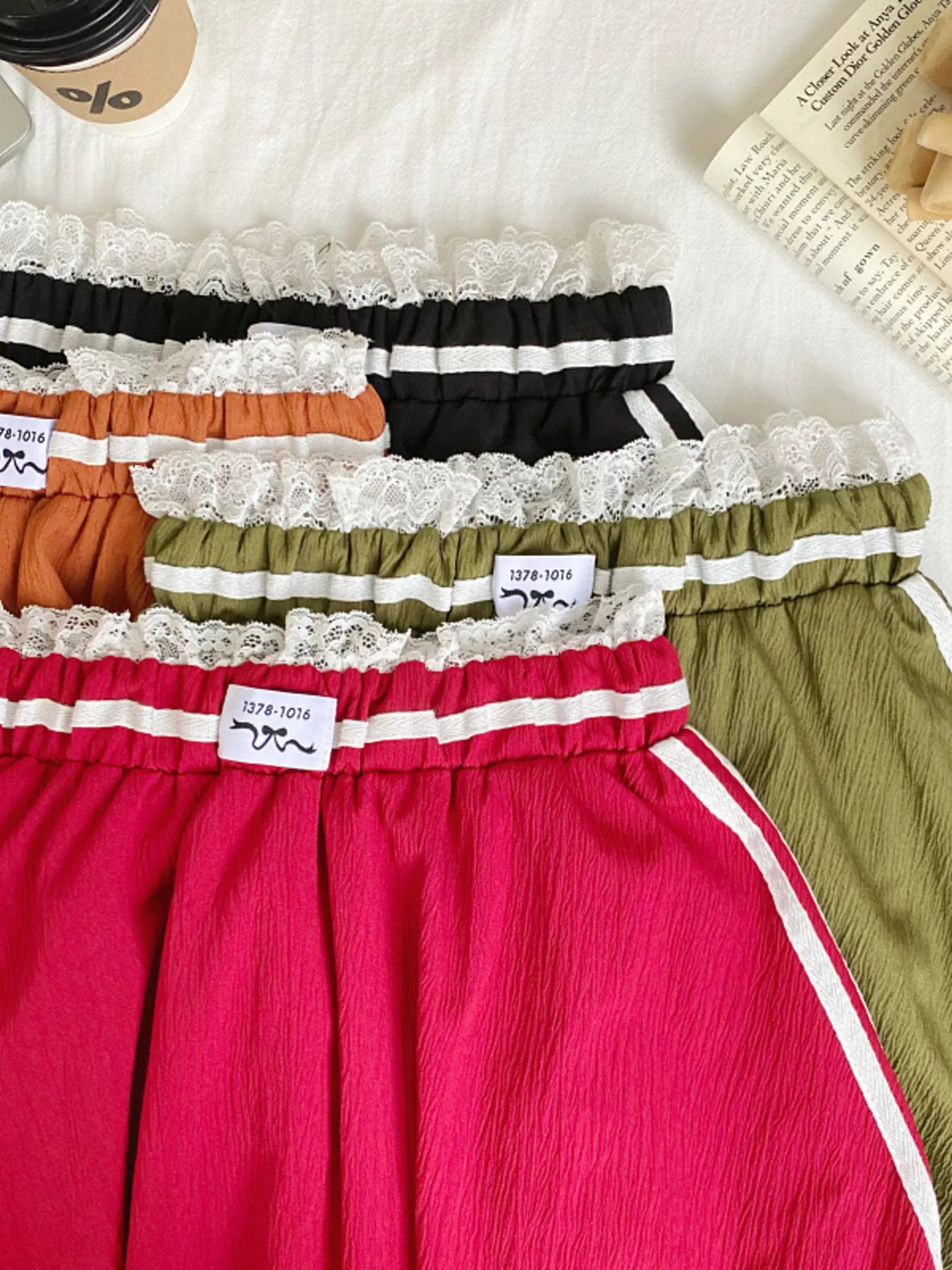 Set of colorful underwear with lace details on a white surface.
