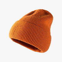 Orange knit beanie on a white background