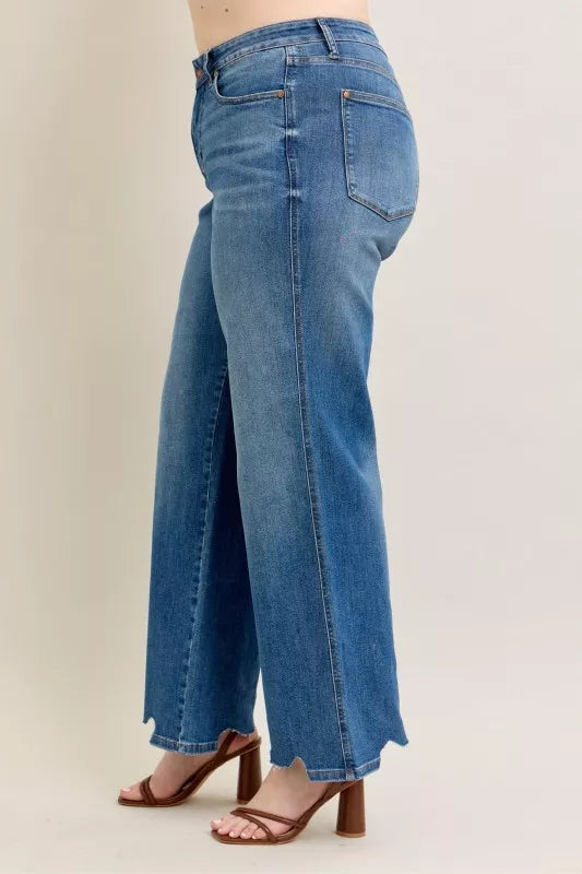 Blue jeans worn by a person on a beige background