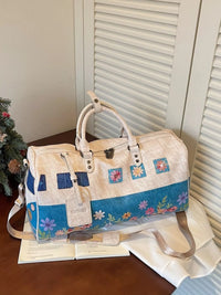 Floral-patterned handbag on a wooden surface with a neutral background