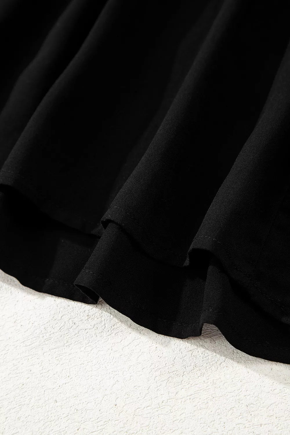 Close-up of a black skirt on a white background