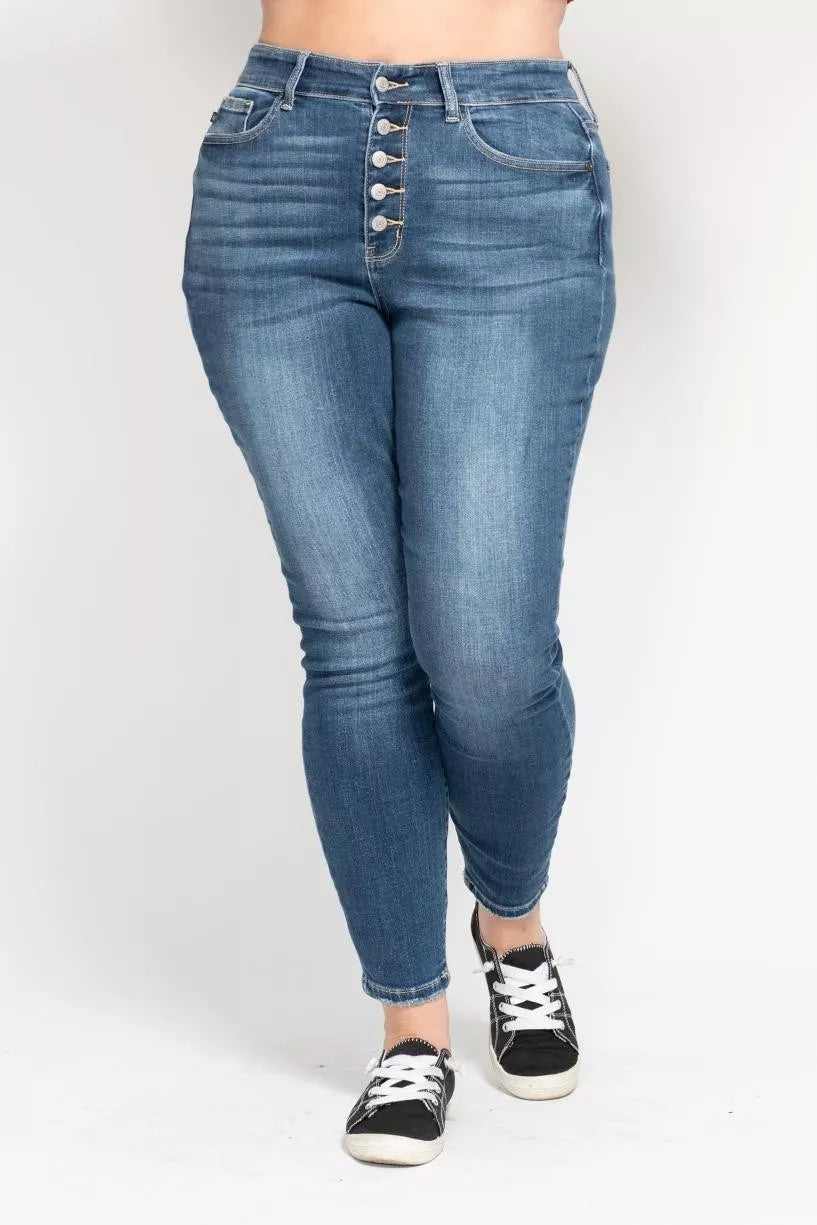 Blue jeans worn by a person on a white background