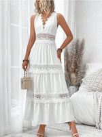 Woman wearing a white lace dress in a bright room.