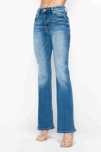 Blue jeans worn by a person on a white background