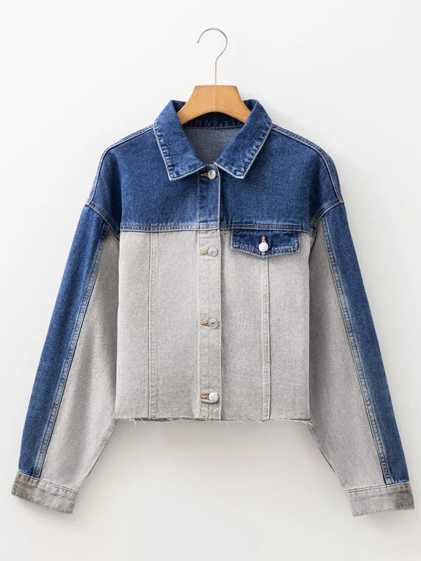 Two-tone denim jacket with blue sleeves and gray body on a white background