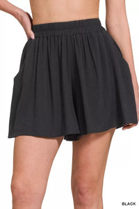 Black skirt worn by a person on a white background