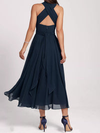 Navy blue evening gown with open back on a white background