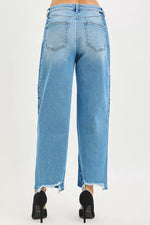 Light blue jeans worn by a person on a white background