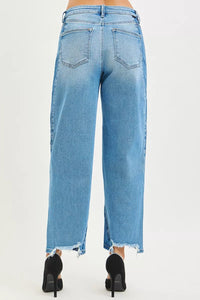 Light blue jeans worn by a person on a white background