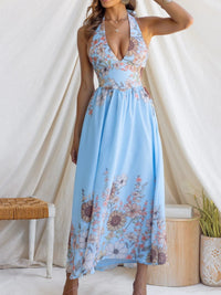 Woman wearing a blue floral dress against a white background
