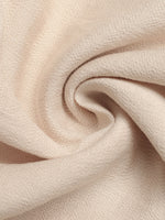 Close-up of beige fabric with a soft texture