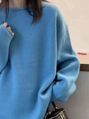 Person wearing a blue sweater with a neutral background