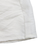 Close-up of a white quilted fabric surface