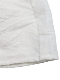 Close-up of a white quilted fabric surface
