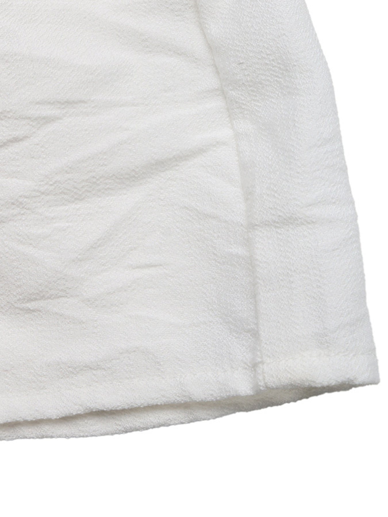 Close-up of a white quilted fabric surface