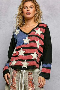 Woman wearing a colorful sweater with star patterns on a gray background