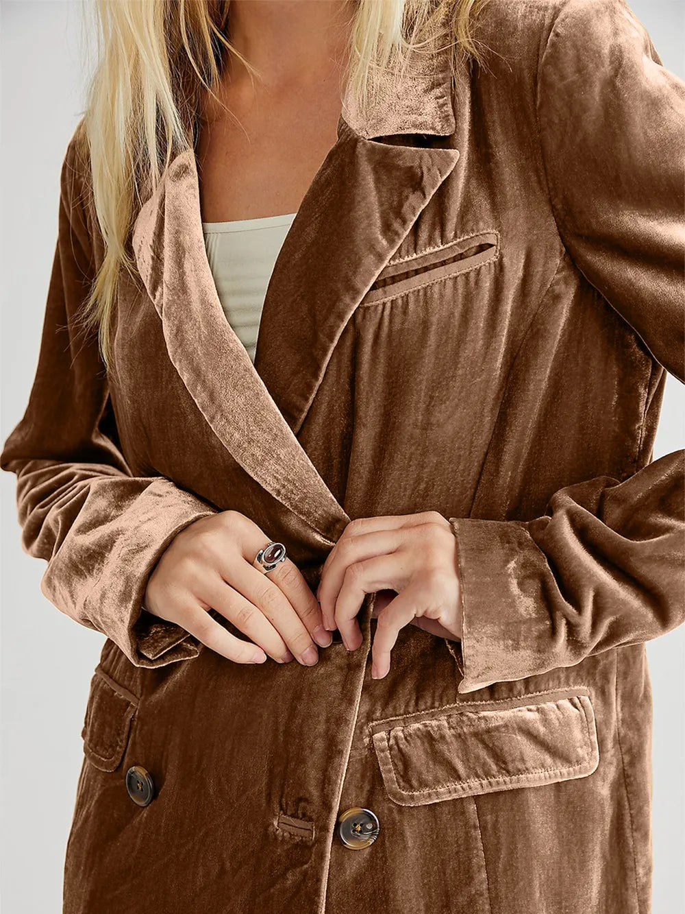 Brown corduroy jacket worn by a person on a plain background