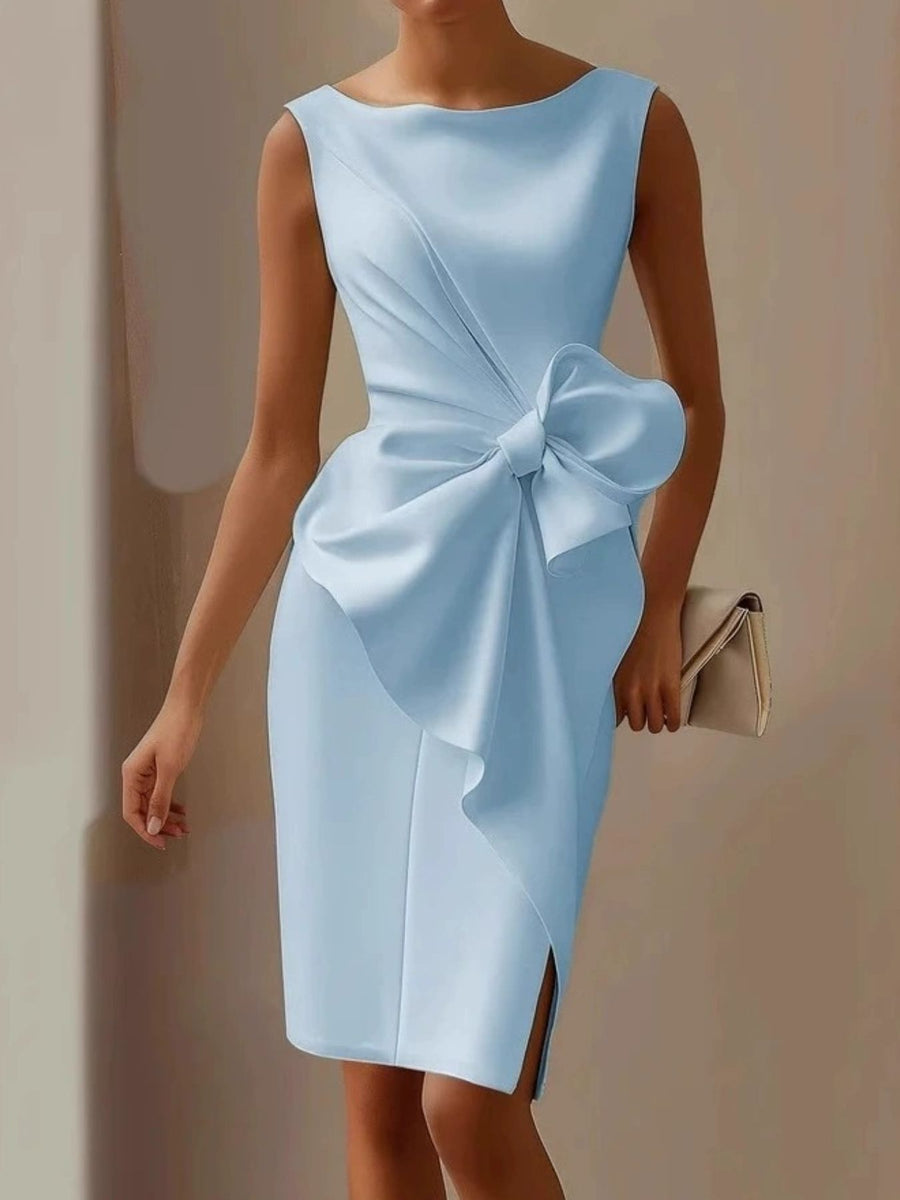 Light blue dress with a large bow detail on a plain background