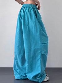 Turquoise wide-leg pants worn by a person on a plain background