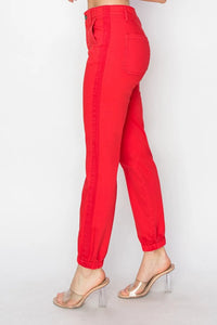 Red pants worn by a person on a white background