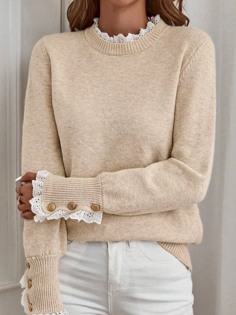 Beige sweater with lace cuffs and buttons on a neutral background