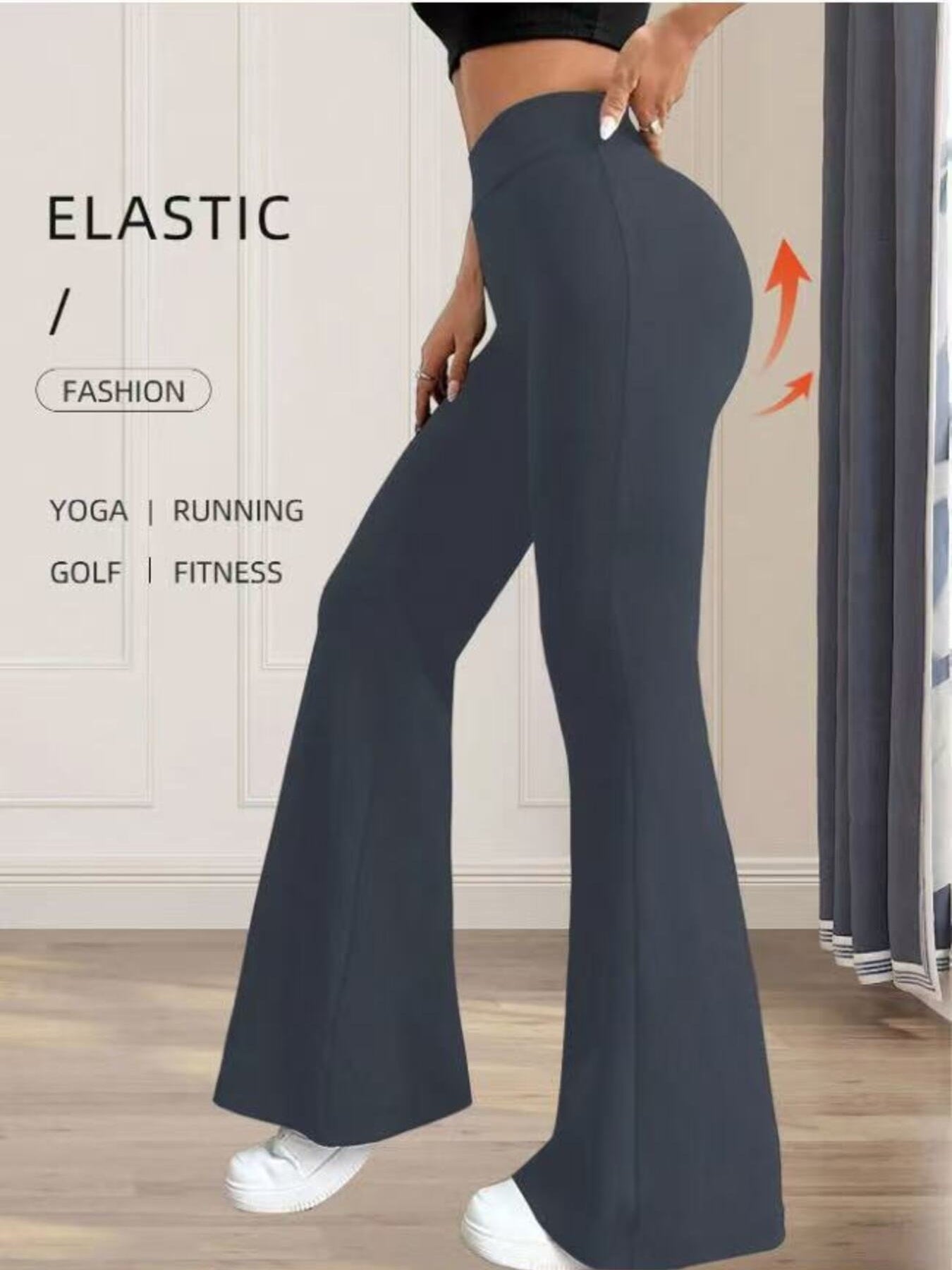 Person wearing dark blue flared pants with text on a neutral background