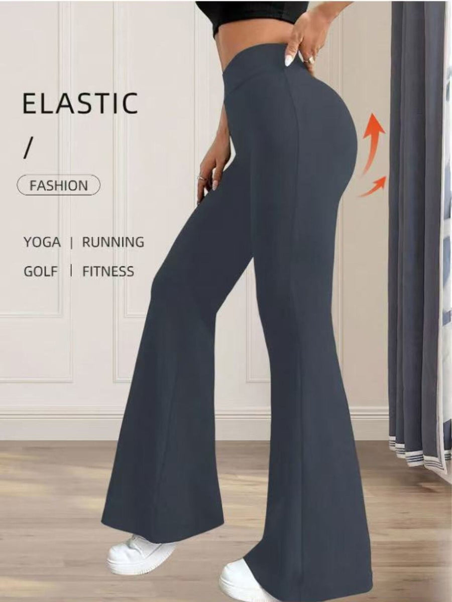 Person wearing dark blue flared pants with text on a neutral background