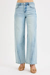 Light blue jeans worn by a person on a white background
