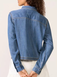 Blue denim jacket worn by a person on a light background