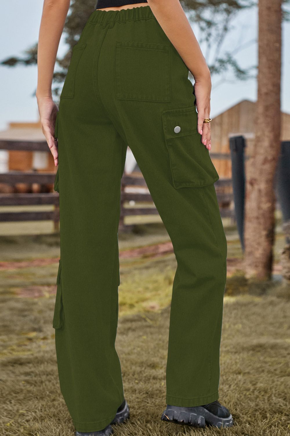 Green cargo pants worn by a person outdoors with a blurred background