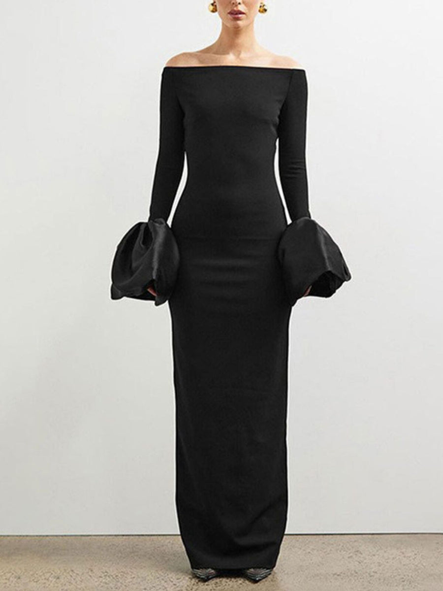 Black off-shoulder dress with long sleeves on a plain background