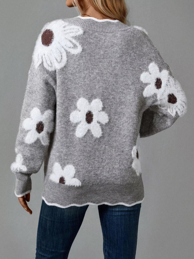 Gray sweater with white floral patterns on a gray background