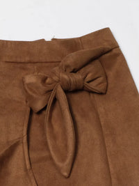 Brown suede skirt with a knot detail on a white background