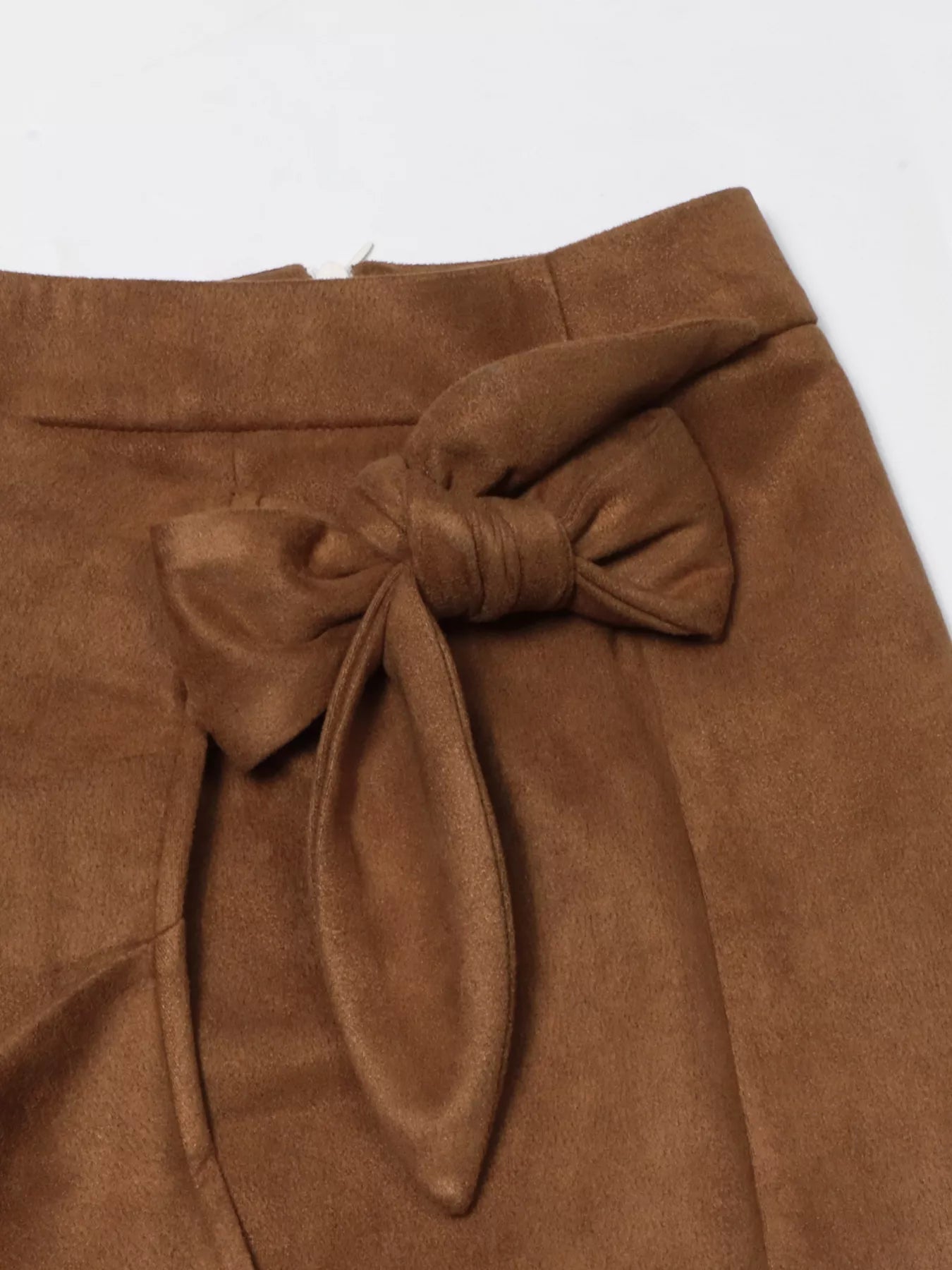 Brown suede skirt with a knot detail on a white background
