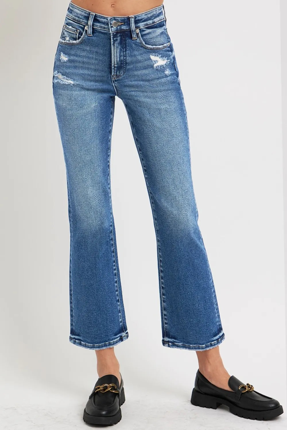 Blue jeans worn by a person on a white background