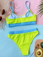 Colorful bikini set with blue and green straps on a pink and blue background.