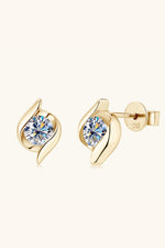 Gold earrings with clear gemstones on a white background